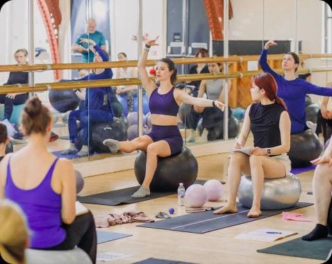 Dance teacher practising PBT conditioning exercises with a resistance band