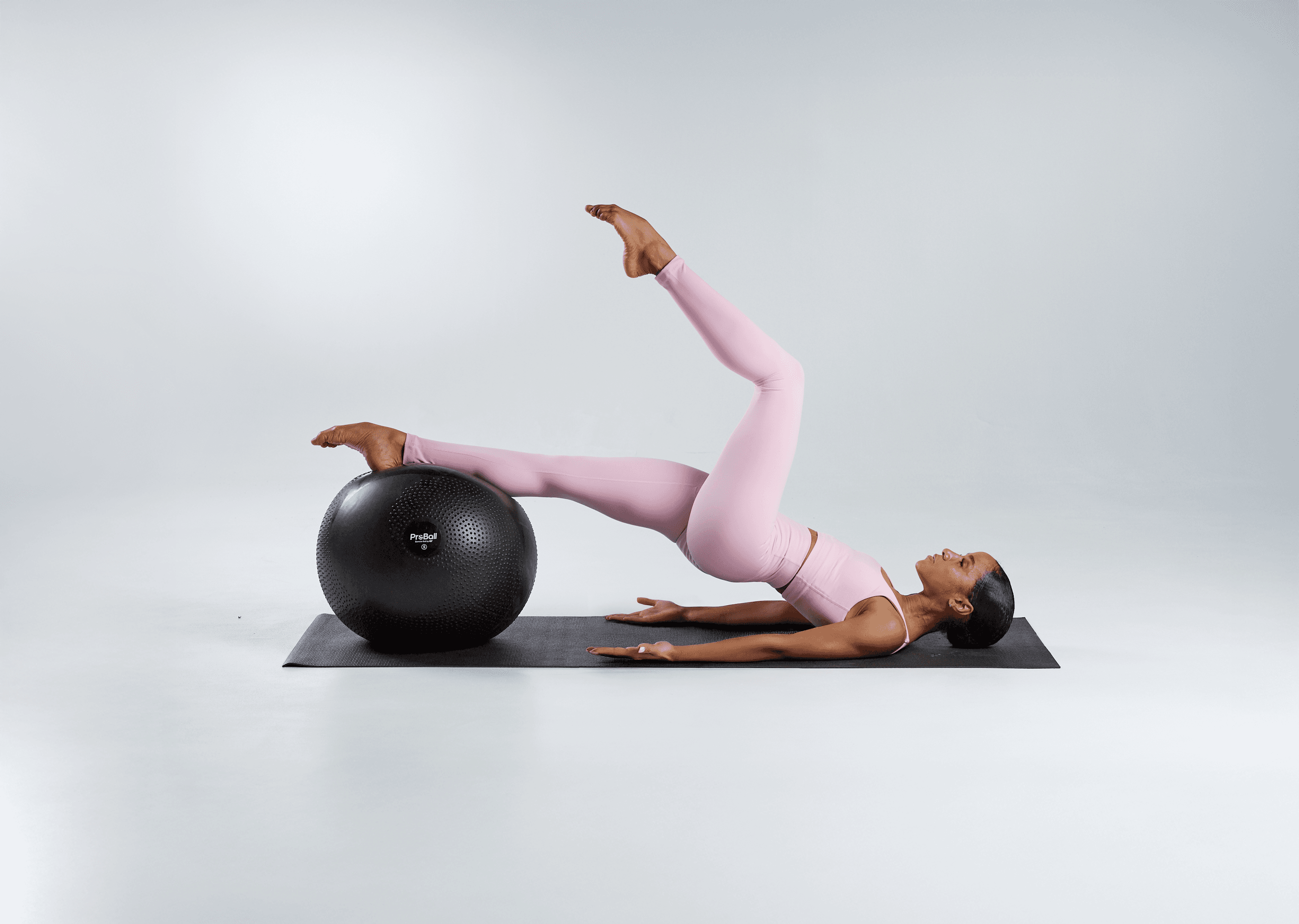 Student dancer training with a PBT exercise ball