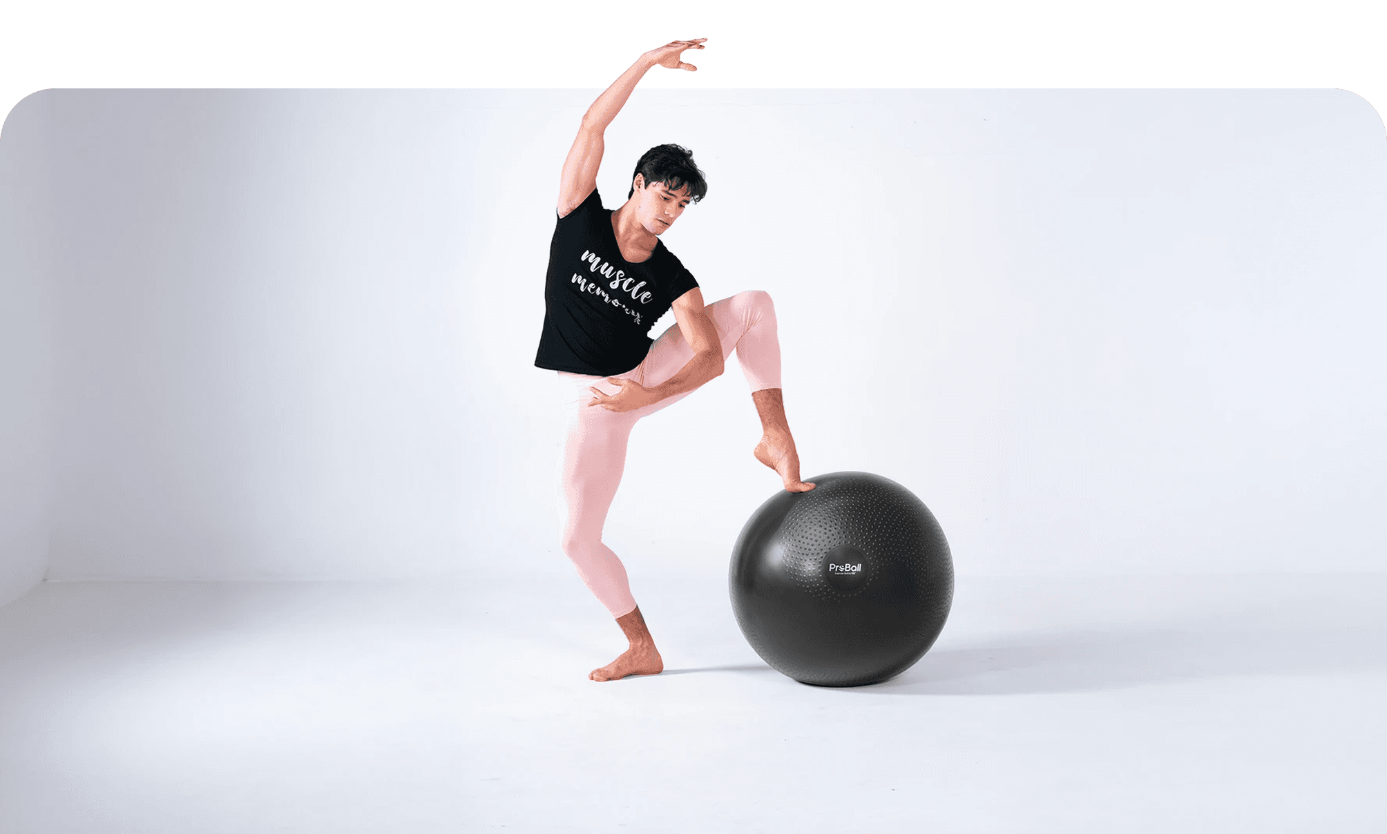 Male dancer using an exercise ball to improve balance